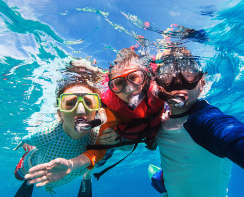 Family snorkeling in La Jolla Cove