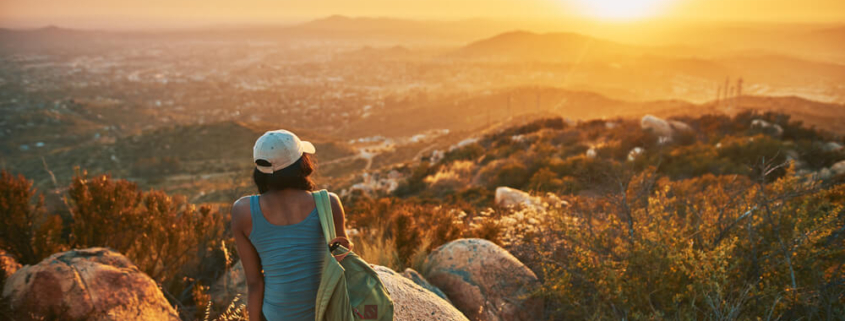 Woman taking in a beautiful view of the sunset on one of San Diego's hiking trails