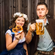 A couple enjoying beer and pretzels at Oktoberfest in San Diego