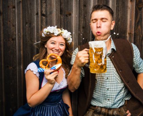 A couple enjoying beer and pretzels at Oktoberfest in San Diego