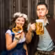 A couple enjoying beer and pretzels at Oktoberfest in San Diego