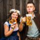 A couple enjoying beer and pretzels at Oktoberfest in San Diego