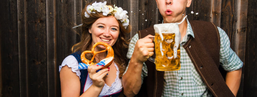 A couple enjoying beer and pretzels at Oktoberfest in San Diego