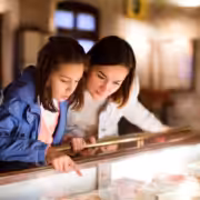 A mom and daughter look at an artifact in one of the best museums in San Diego