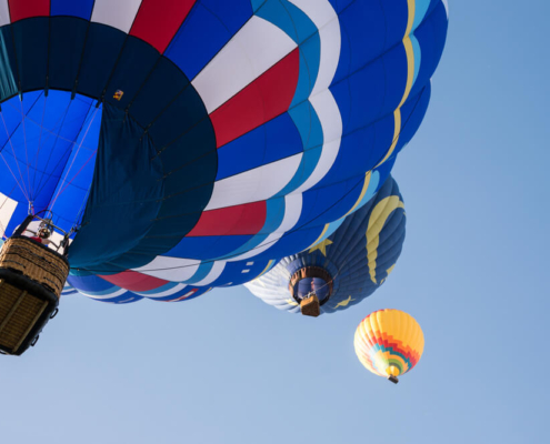 Three hot air balloons over San Diego