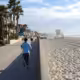 A person running on the Mission Beach boardwalk, one of the top things to do in the area