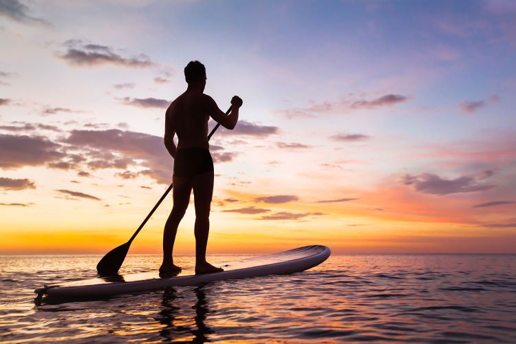 Picture of a man on a paddleboard at sunset on Mission Bay in Mission Beach
