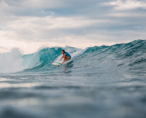 A man surfing in Pacific Beach, one of the top things to do in the area