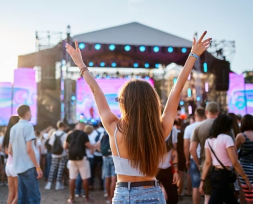 A woman enjoying a fall music festival event in San Diego