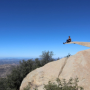 A man sitting on Potato Chip Rock, one of the best Instagram spots in San Diego