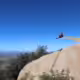 A man sitting on Potato Chip Rock, one of the best Instagram spots in San Diego